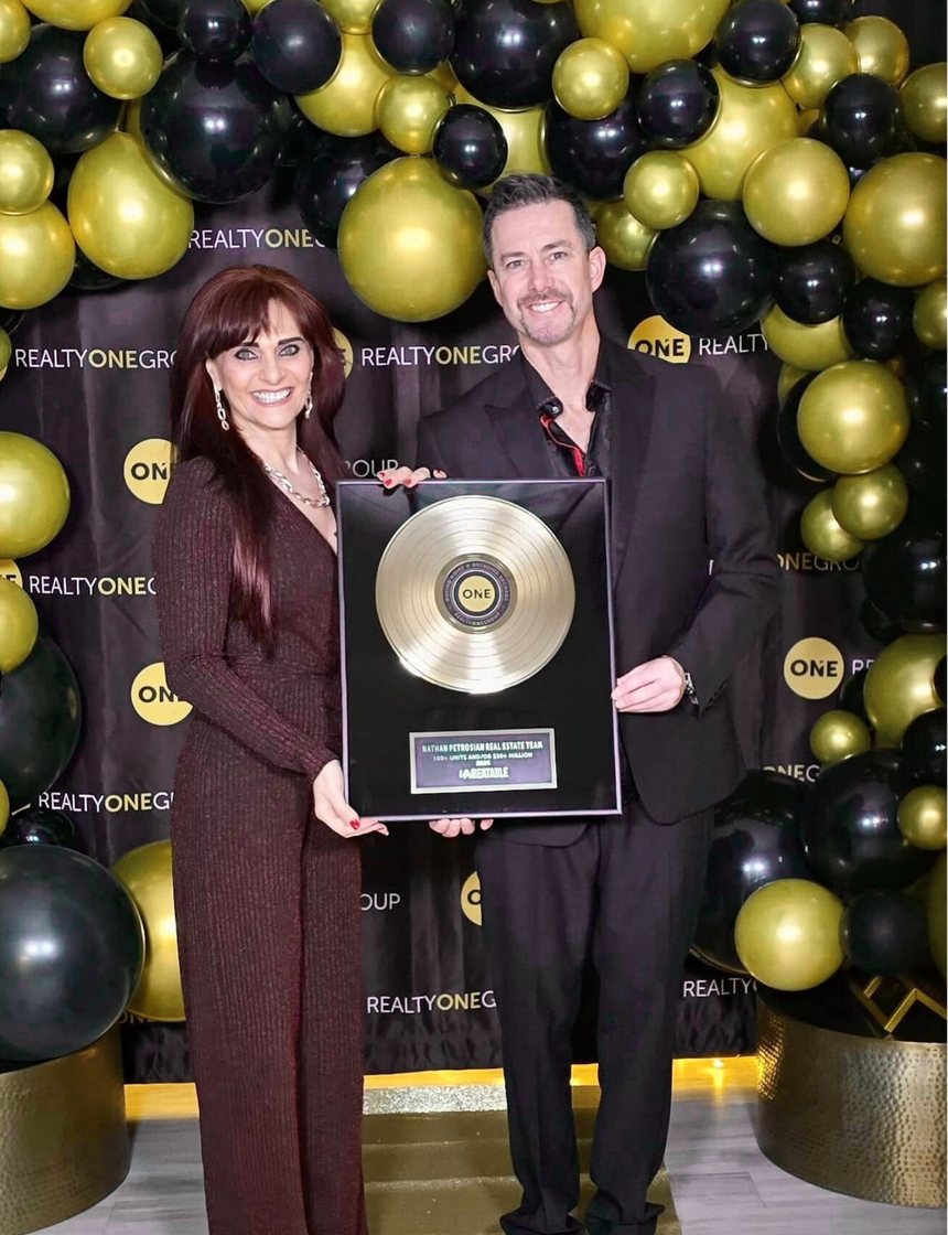 Nathan Petrosian receiving a Realty ONE Group award