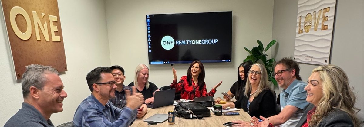 Petrosian team meeting in the Realty ONE Group office